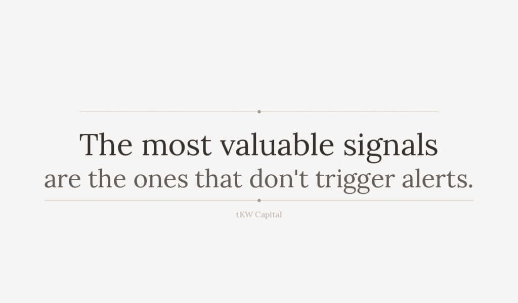 Minimalist text graphic with the quote: “The most valuable signals are the ones that don’t trigger alerts.” on a light neutral background.
